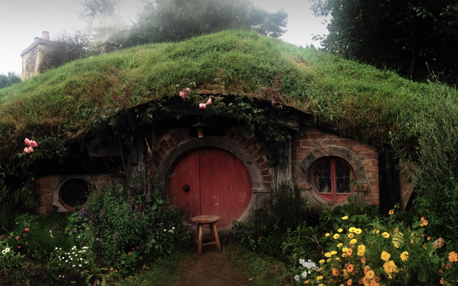 the hobbit house garden travel architecture wood building landscape tree flower mountain summer outdoors home nature