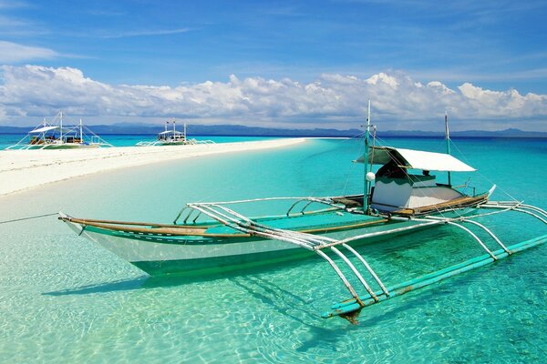 Boat to a tropical beach with white sand