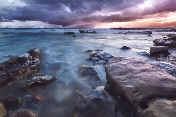 Stone seashore at sunset