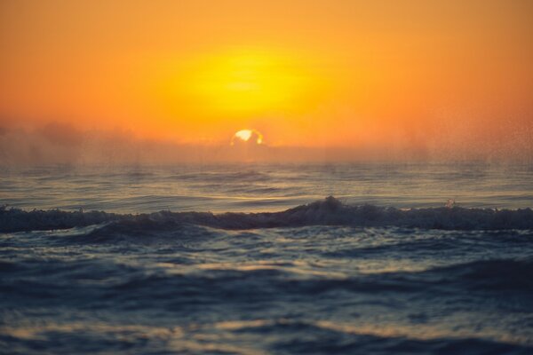 The undulating sea with fog at sunrise