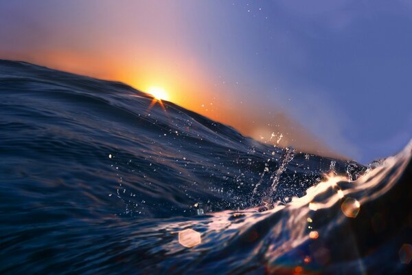 Waves cutting through an exciting sunset