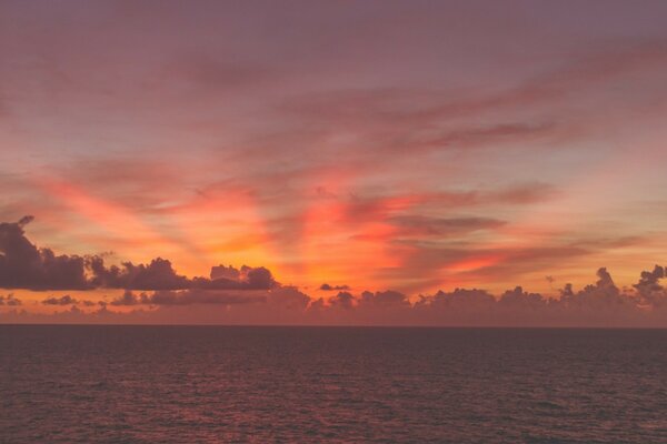 A ray of sunlight melted the twilight over the water