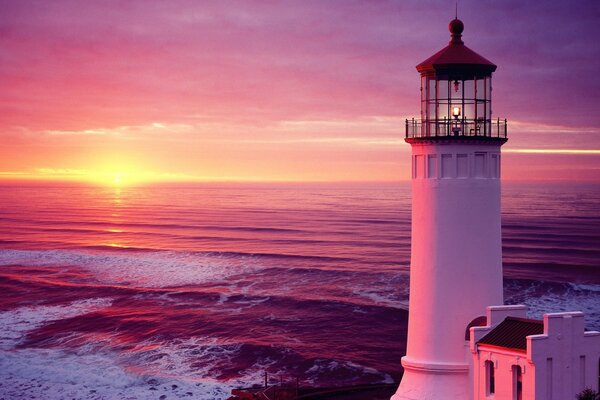 Lighthouse on the background of purple sunset rays