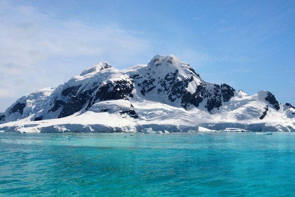 Snow-capped mountains by the water