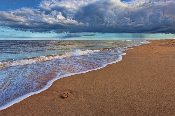 Waves on the sea, sand, beautiful clouds