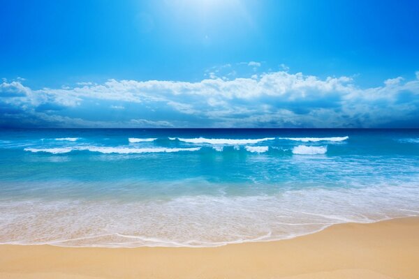 Sandy beach washed by beryuzov waves of the ocean