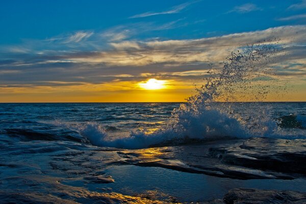 Blue wave splash and yellow sunlight