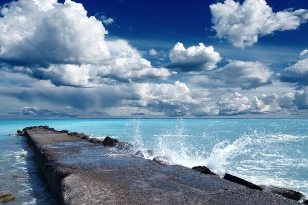 Pier waves Ocean sky clouds