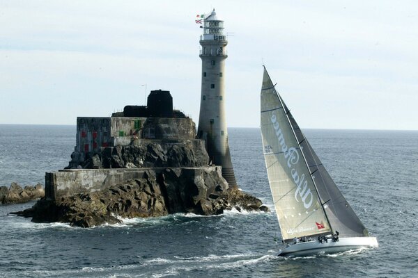 Lighthouse surrounded by a smooth surface of water