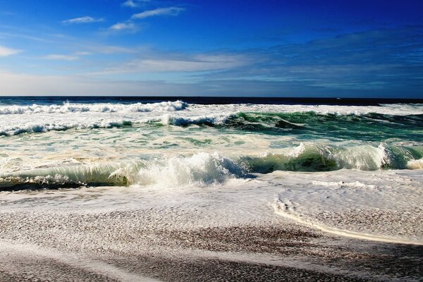 Sea foam and waves on the beach