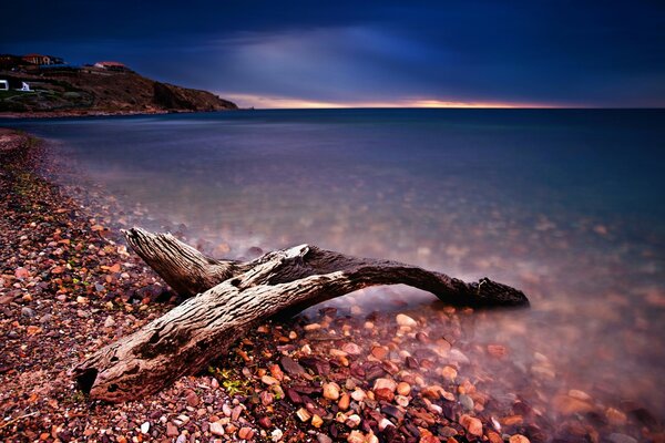 Sunset, water. Beach and pebbles