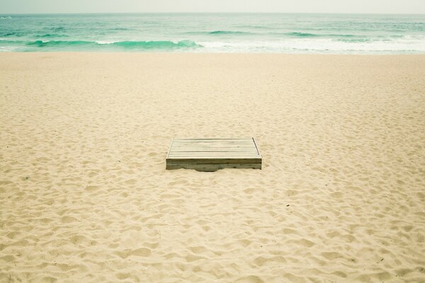 A box buried in the sand on the beach