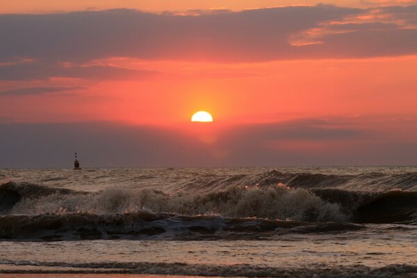 The sun sets against the background of the sea