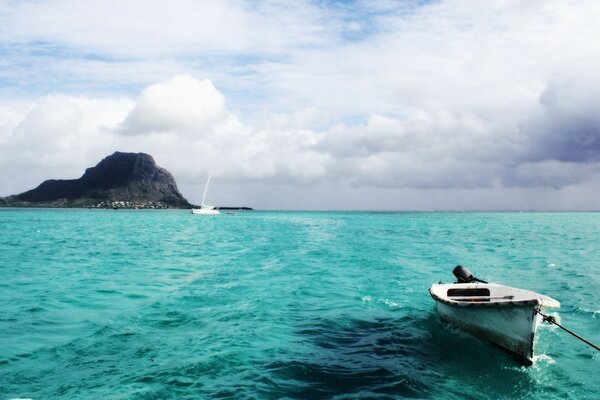 A boat on blue water. Thick clouds