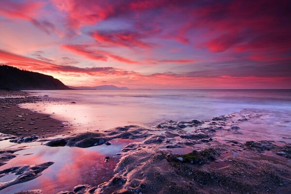 The crimson sky and the stone seashore