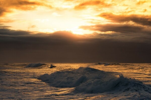 Stunning sunrise on the beach of the undulating sea