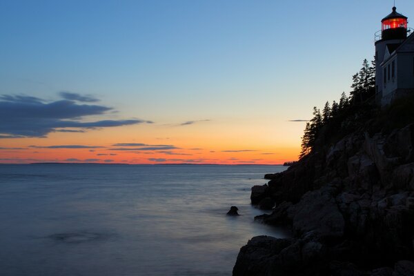 The lighthouse on the rock lit the lights