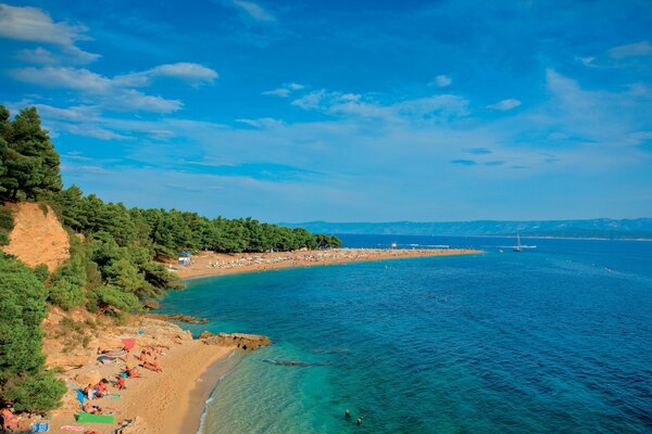 People relax on the beach