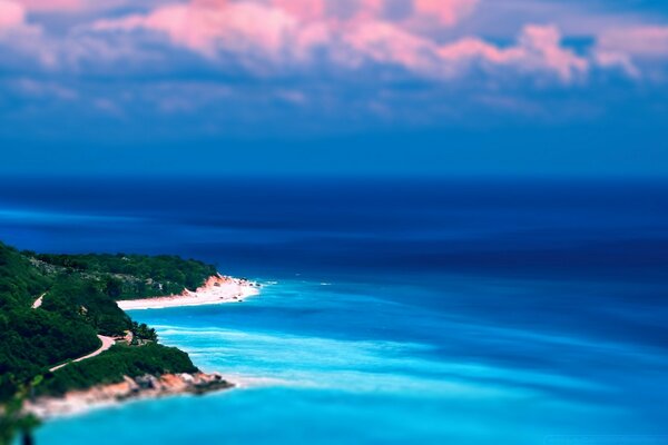 A paradise island in the sea under a blue sky with pink clouds