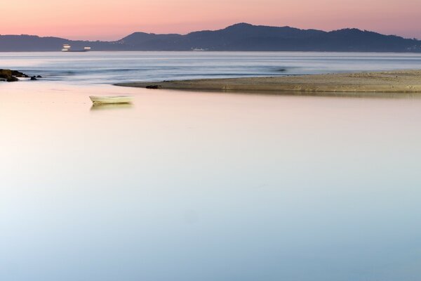 Pink sky over blue ocean