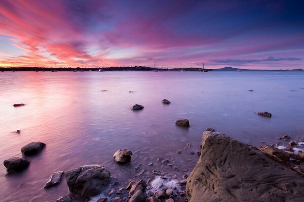 Pedras na água do oceano noturno