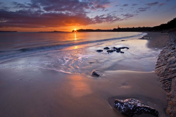 The dawn is reflected on the surface of the ocean