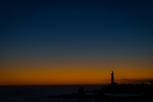 Lighthouse at sunset in blue and orange tones