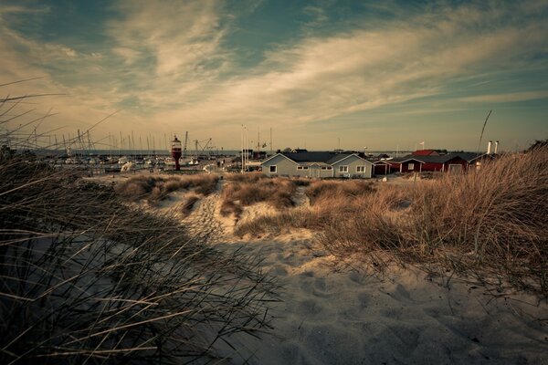 Seaside town with sandy road