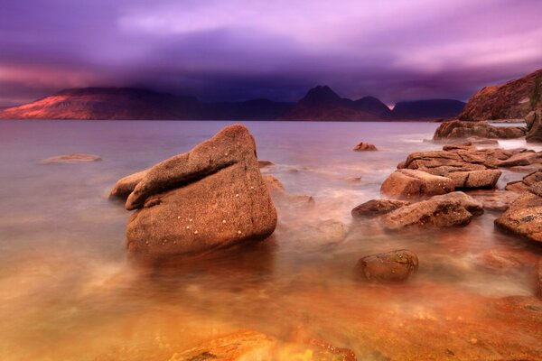 Sunset over rocks and sea