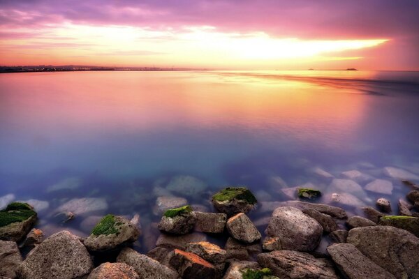 Reflection of the sea in the sunset rays