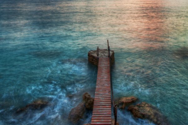 Wooden bridge on the background of the ocean
