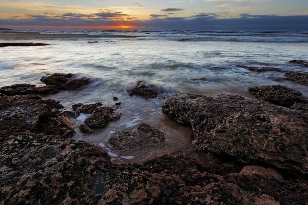 Rocky ocean shore in the sunset