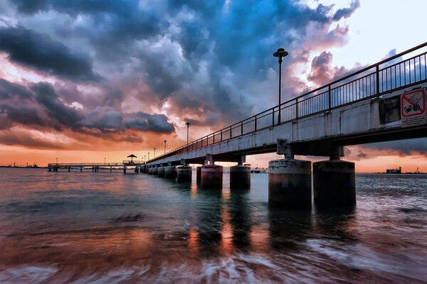 Alte Brücke über das Wasser bei Sonnenuntergang