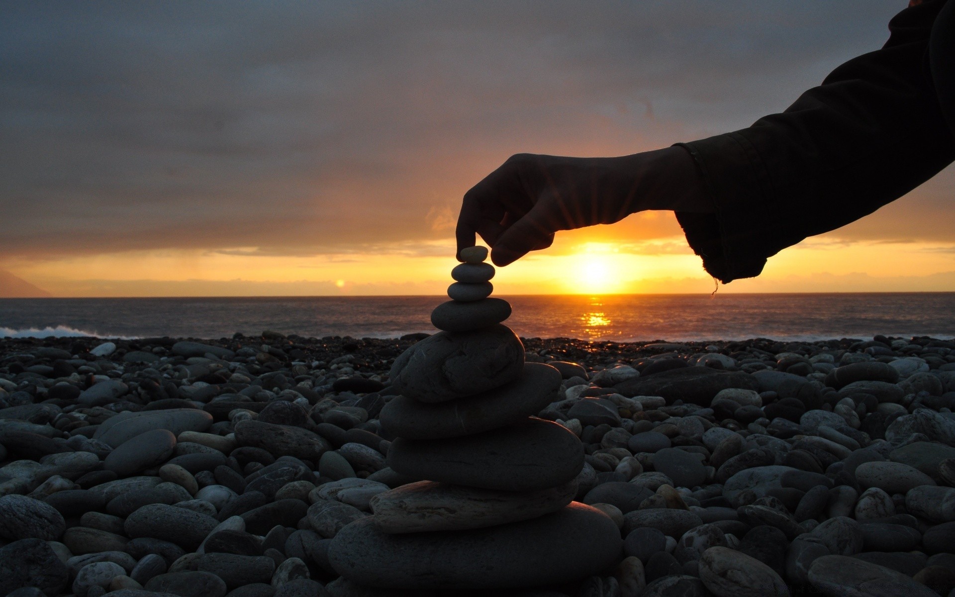 sea and ocean sunset rock beach sky water sea ocean sun evening seashore nature dusk outdoors dawn landscape balance travel stone