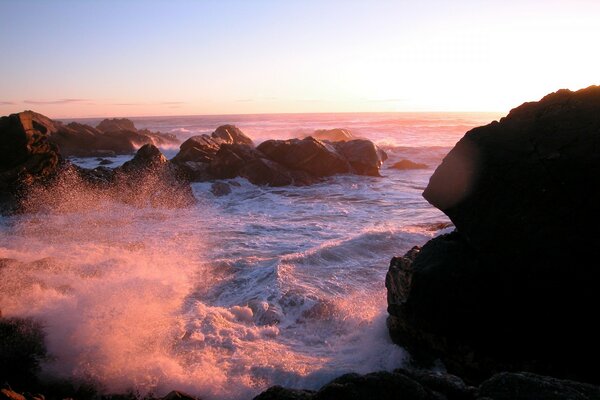 White waves rocks sky