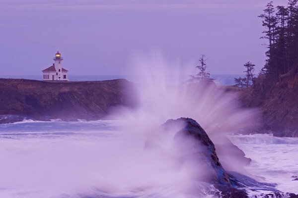 A lonely lighthouse on the shore of a snowy ocean