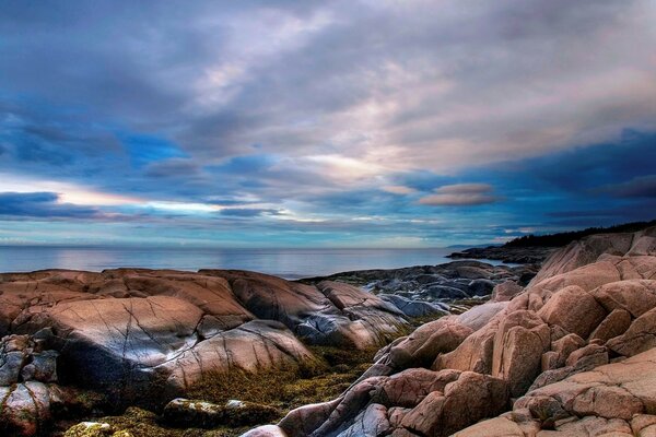 Interesting beautiful sky over the sea and rocks