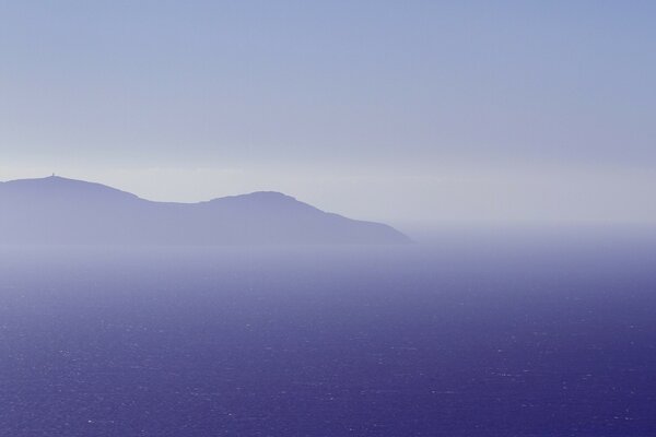 Unreal fog over mountains and ocean