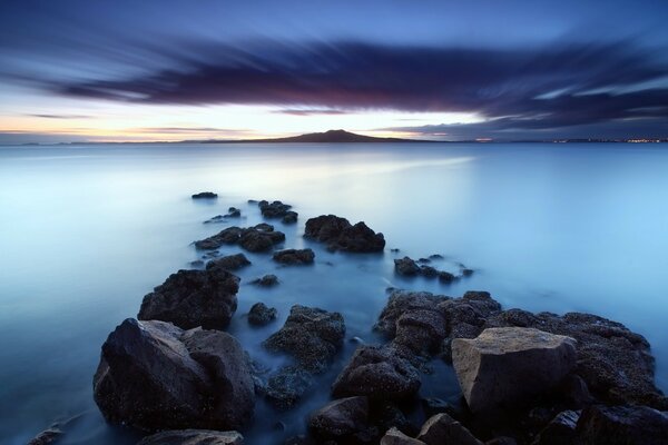 The rocky shore is drowned in milky water