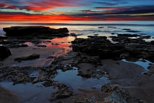 Sunset on a wild beach. Uncharted places