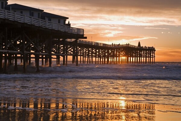 Wooden houses over the ocean at sunset