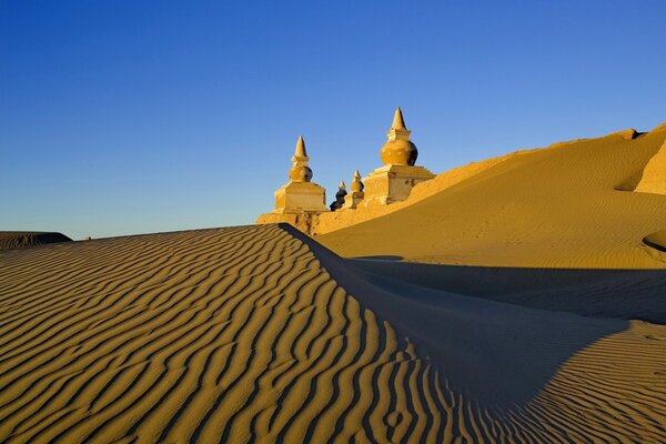 Sand castle under a blue sky