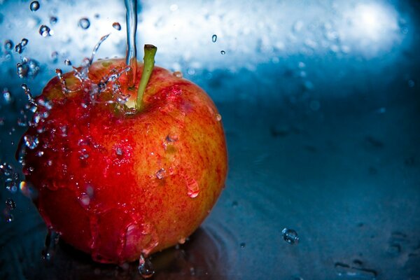 Water falling on an apple