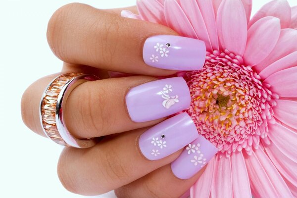 Beautiful manicure on the background of a flower