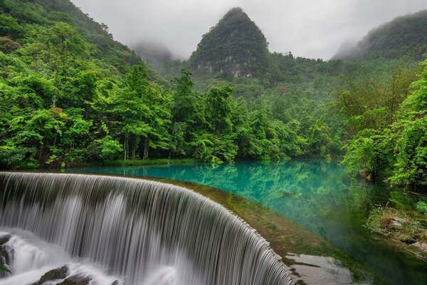 Landscape mountains forest and waterfall
