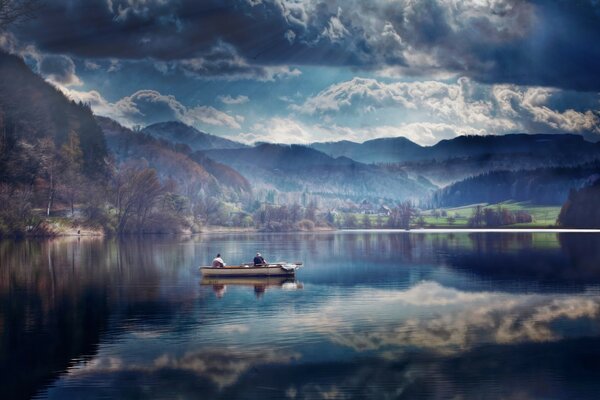 Landscape mountain lake with a boat on the water