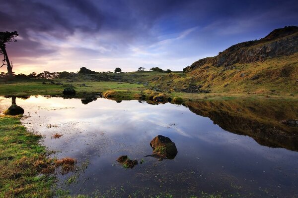 Beautiful landscape with an unusual sky over the river