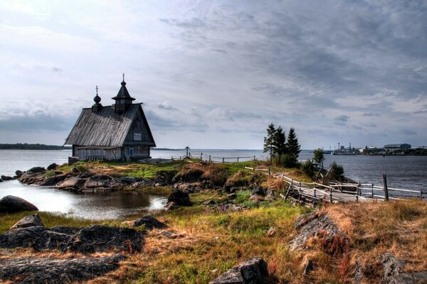 A hut on a rocky shore in autumn