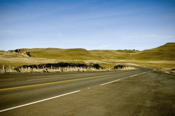 A lonely road among hills and dunes