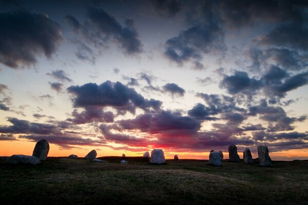 Sunset in the field, landscape with lonely stones